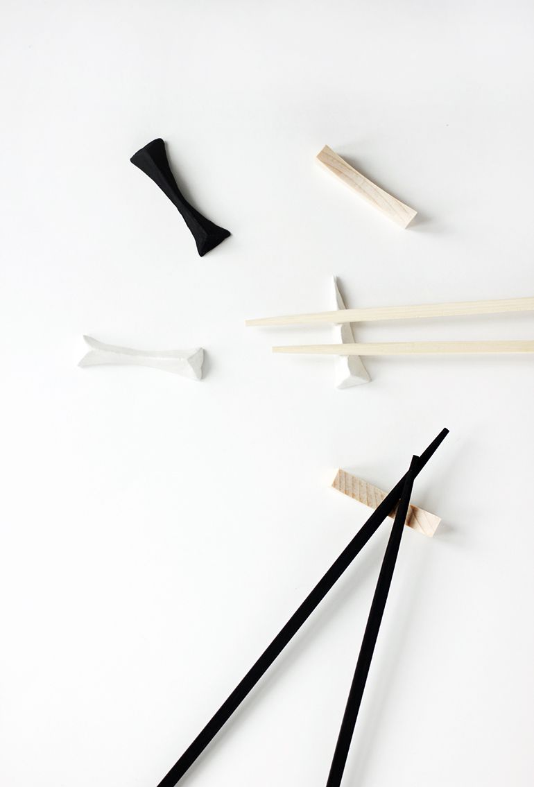 Black and white chopsticks resting on white DIY chopstick rests