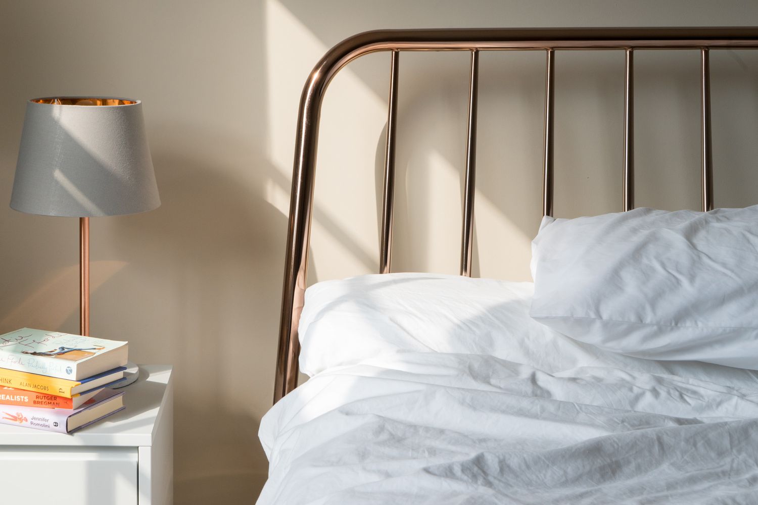 Closeup shot of an unmade bed and white bed sheets