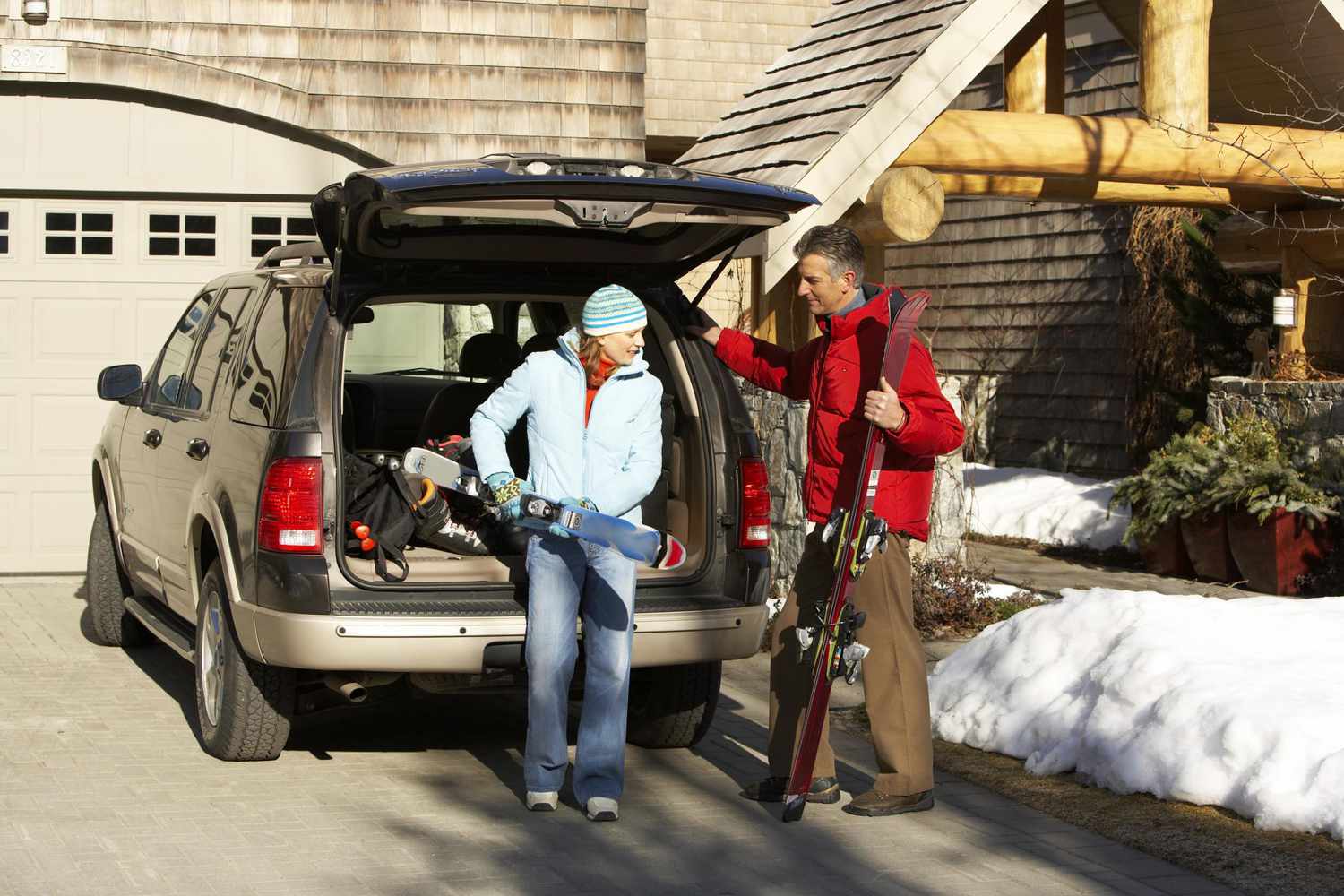 Couple loading car to go skiing