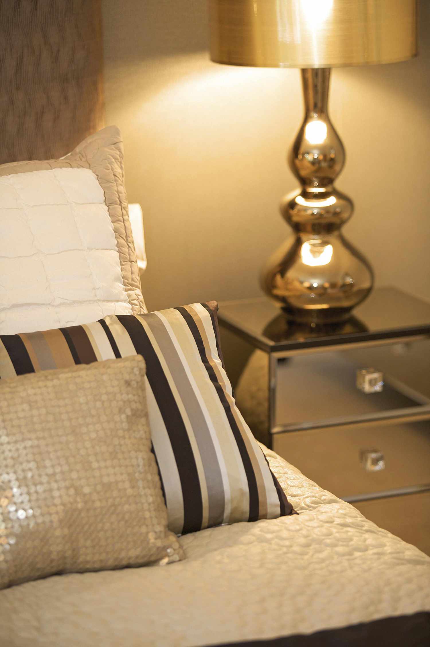 Metallic pieces reflect light and add bling to the bedroom