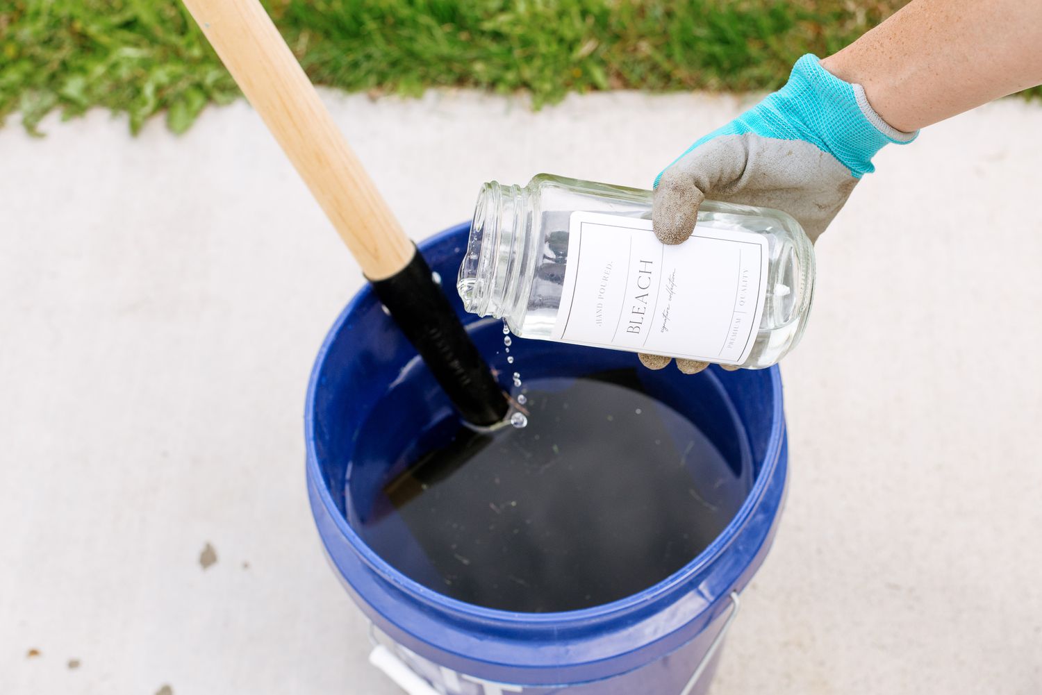 Shovel placed in bucket with water and bleach for sanitizing after removing dead bird