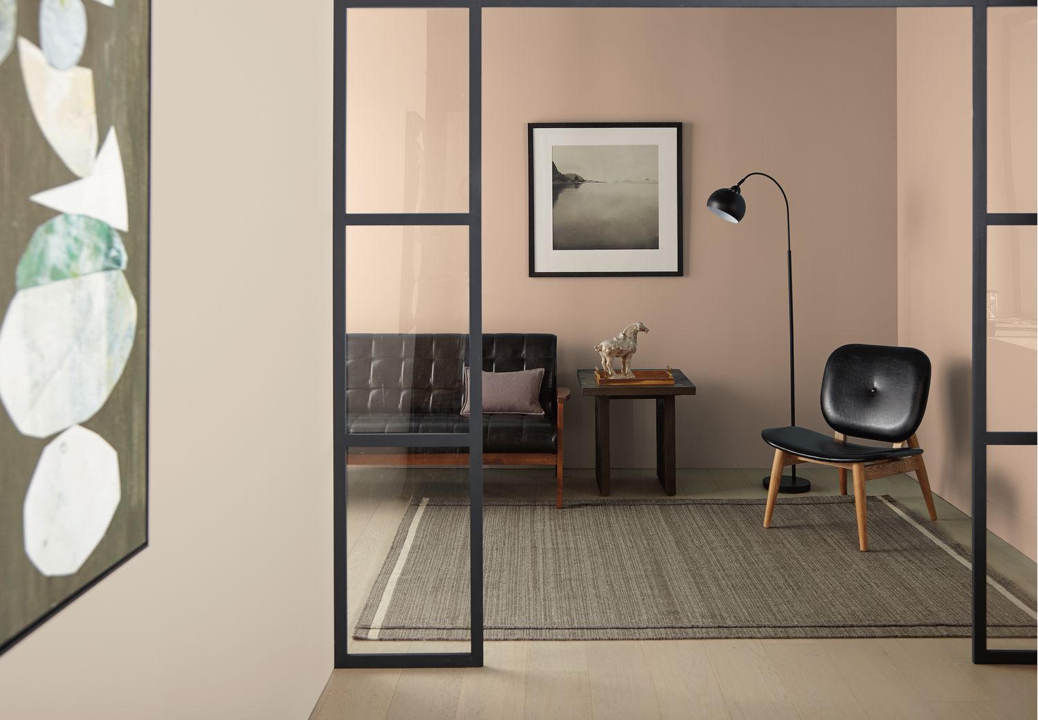 Wohnzimmer mit neutraler Farbe, schwarzen Möbeln und schwarzen Dekorationsartikeln