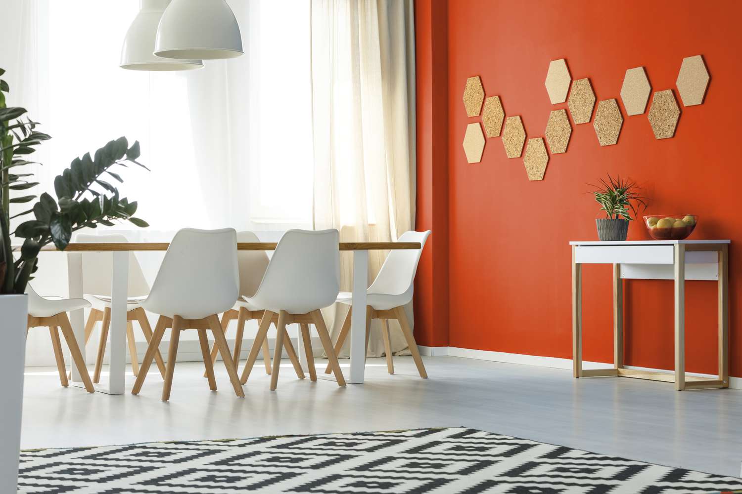 Salle à manger avec mur peint dans une couleur orange vif