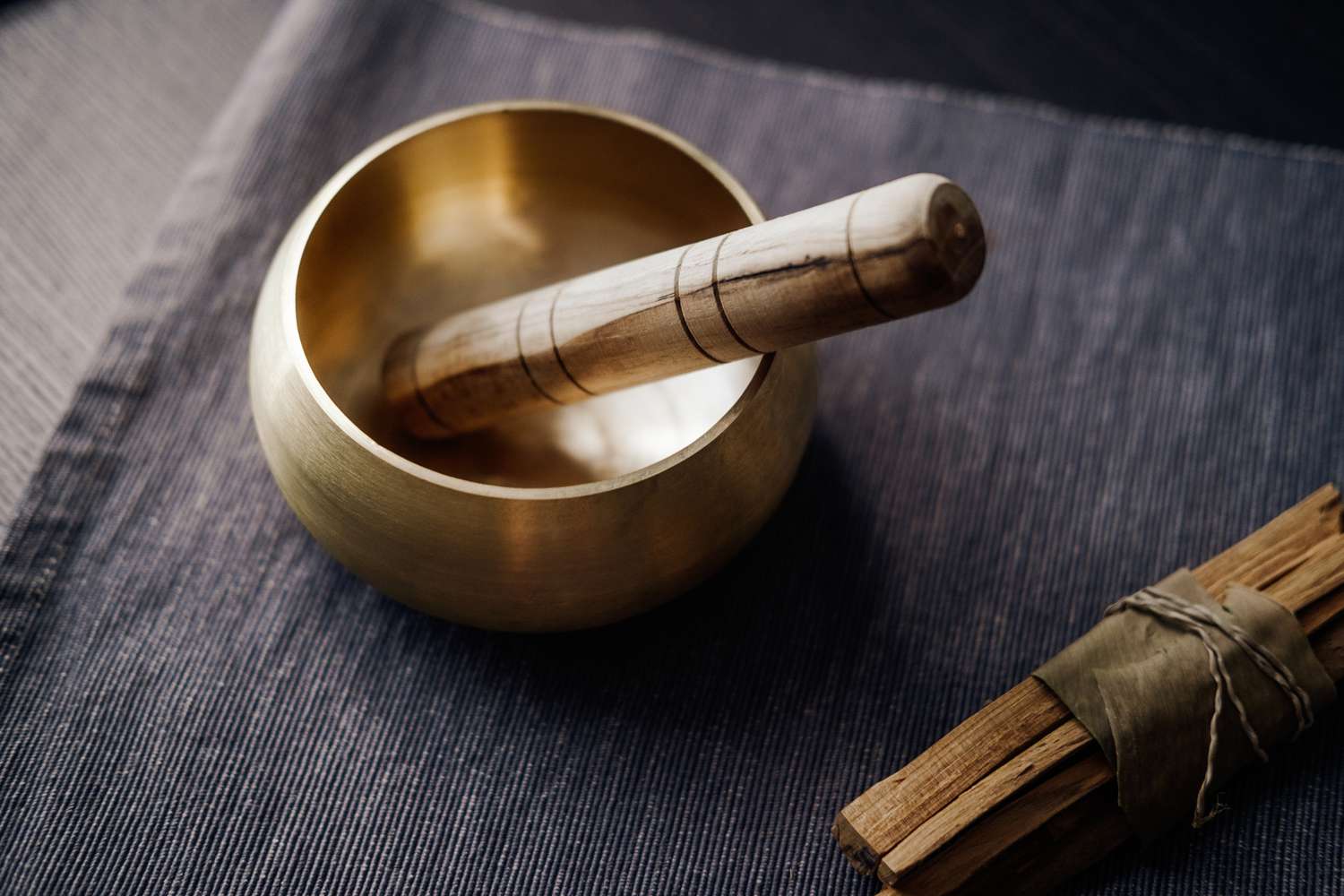 Singing bowl with palo santo for space clearing