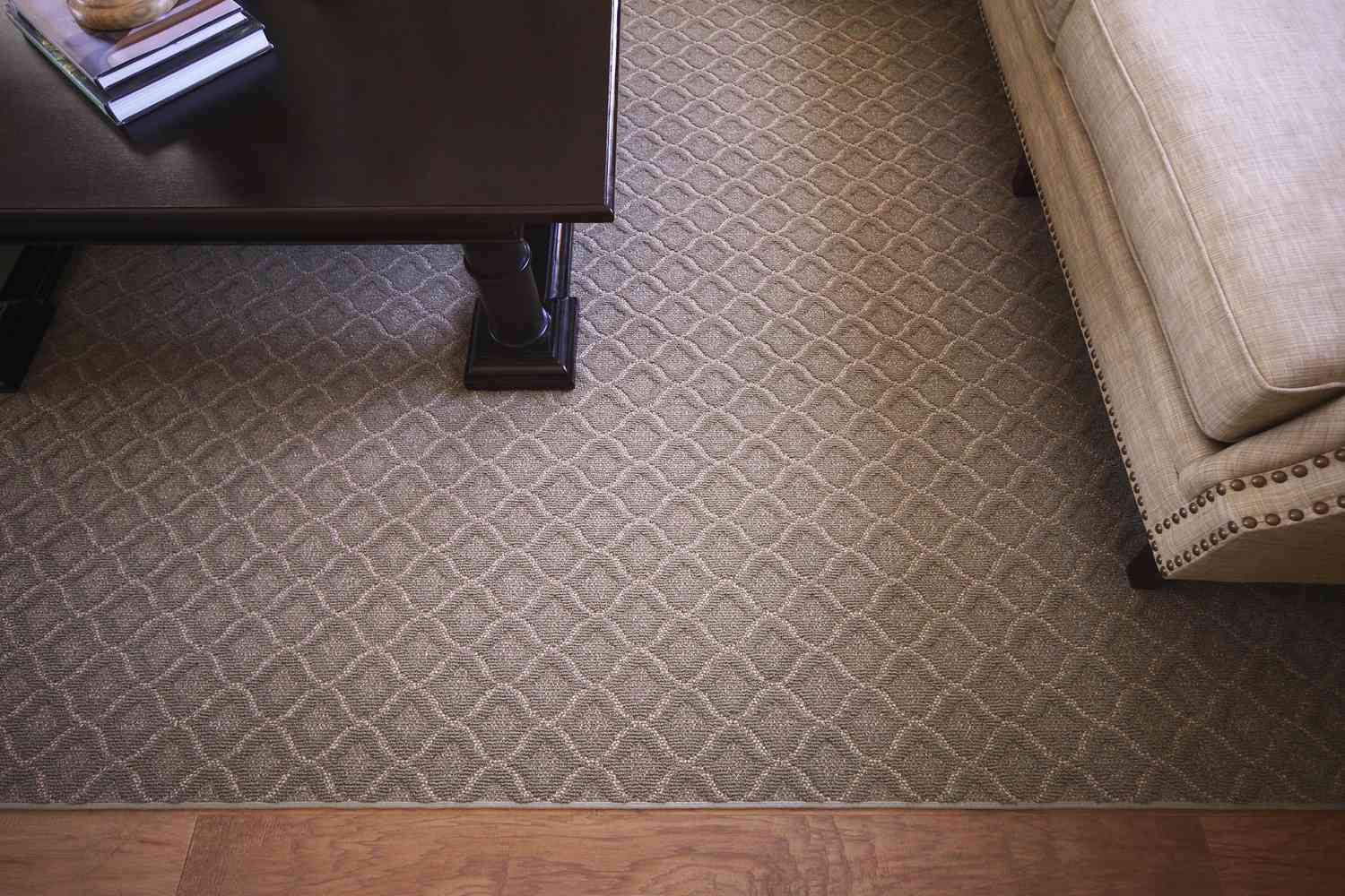 Patterned broadloom in greige color made into area rug.