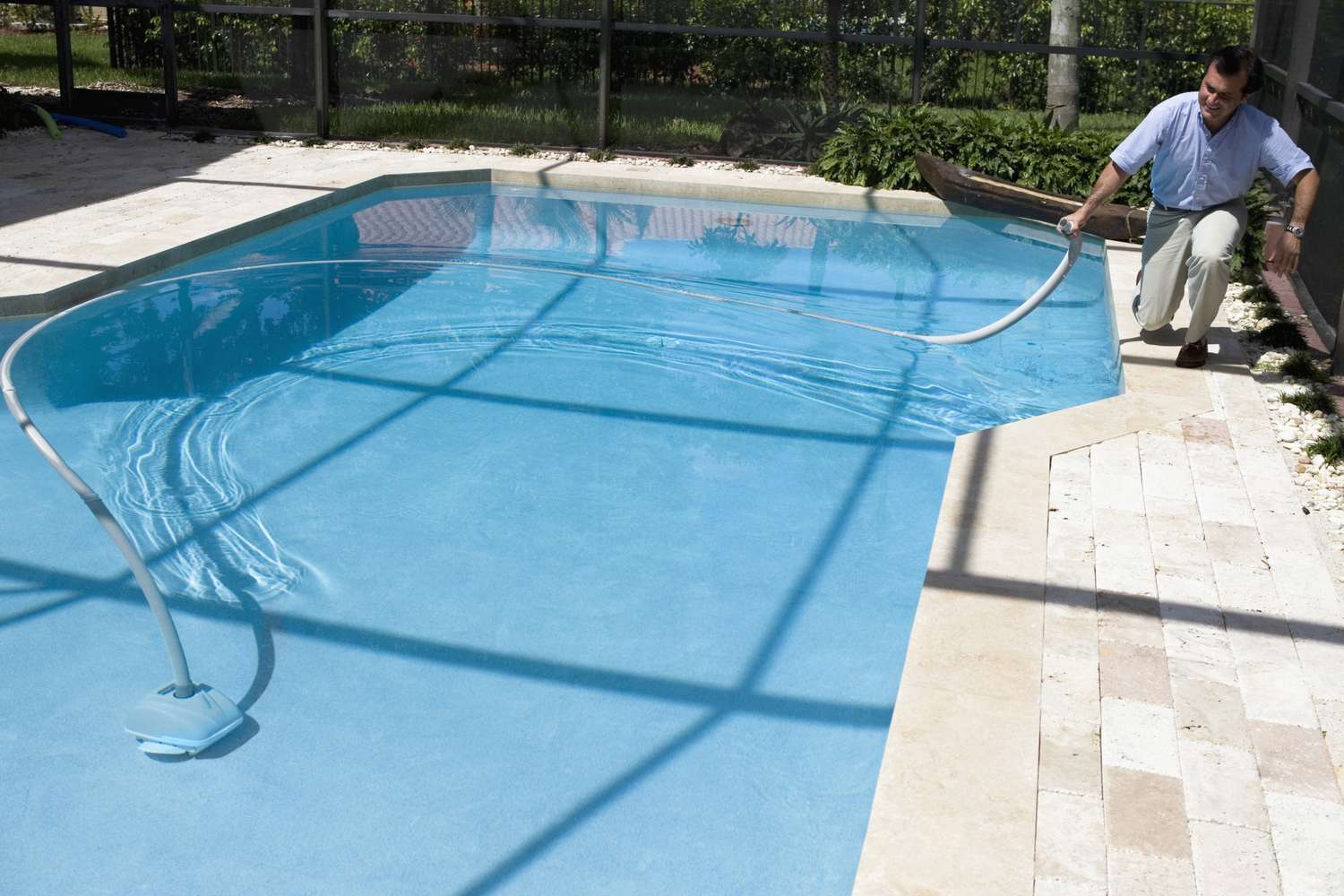 man cleaning pool