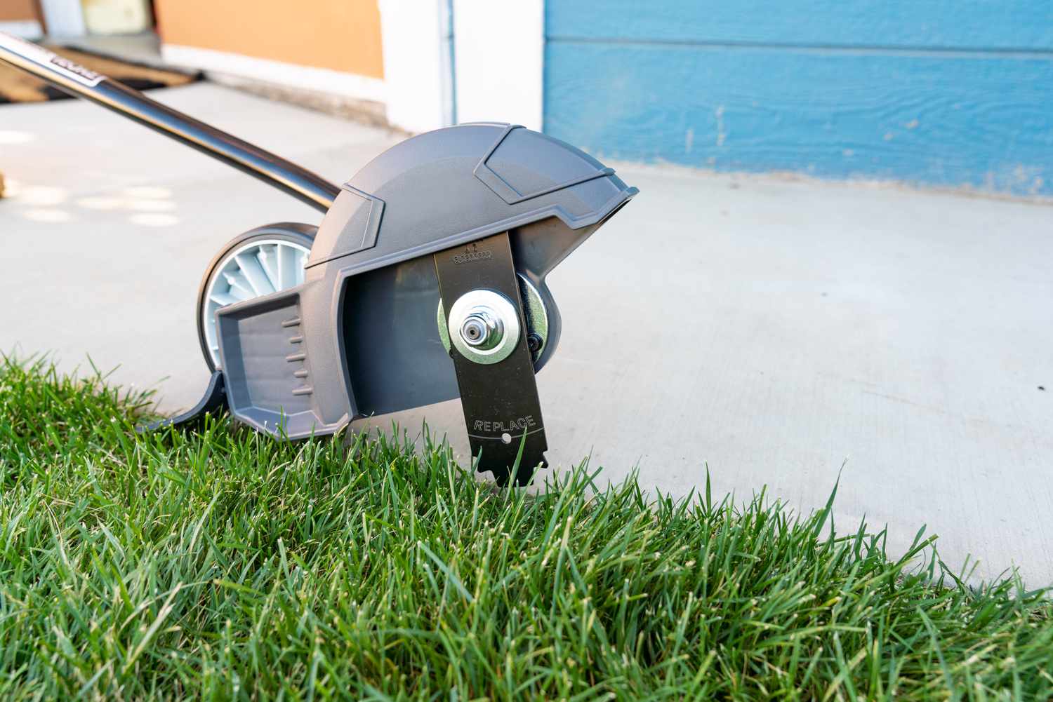 Edging tool being used on a lawn