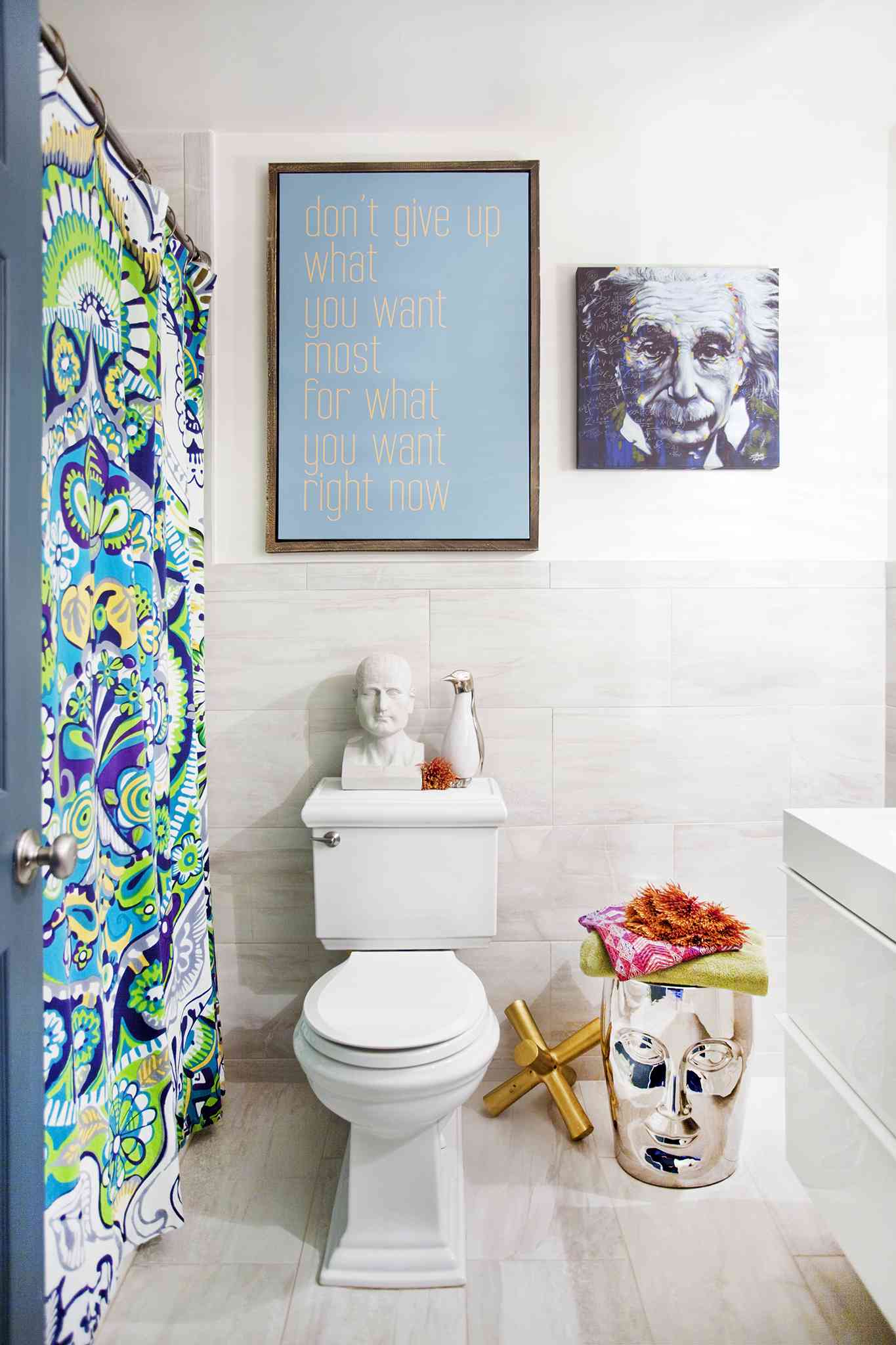 Beth Diana Smith's primary bathroom features a colorful shower curtain and unique art