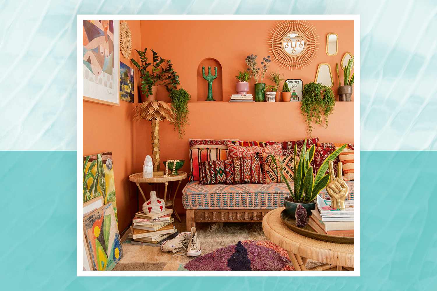 Justina Blakeney living room warm terra cotta walls, plants, and colorful rug, pillows, and wall art for Jungalow