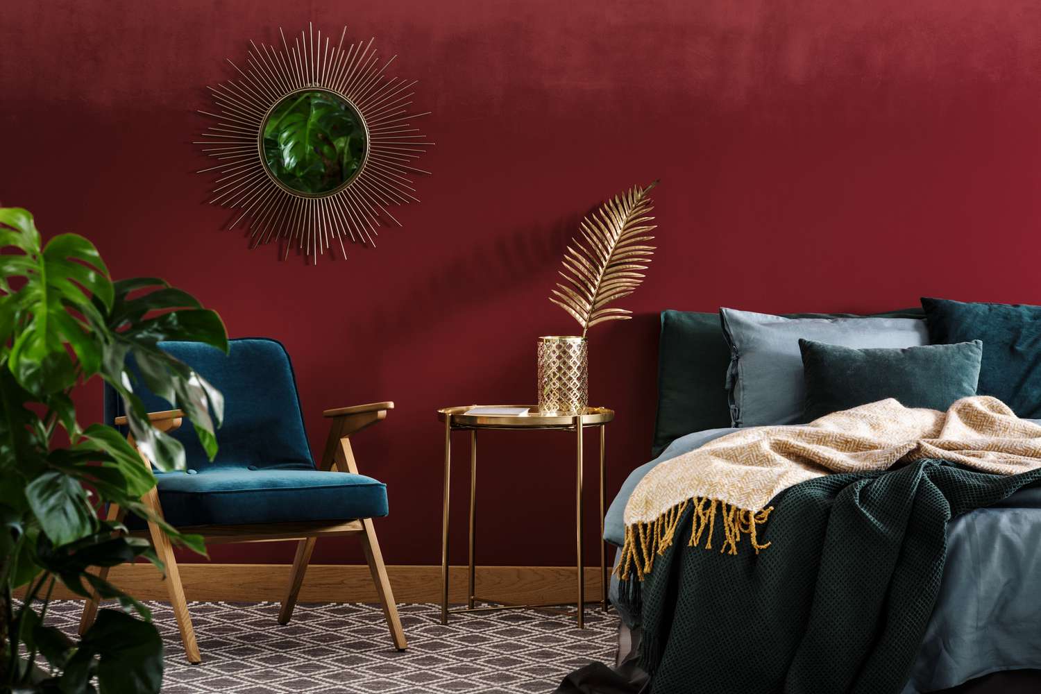 bedroom with burgundy red wall and gold with blue accents