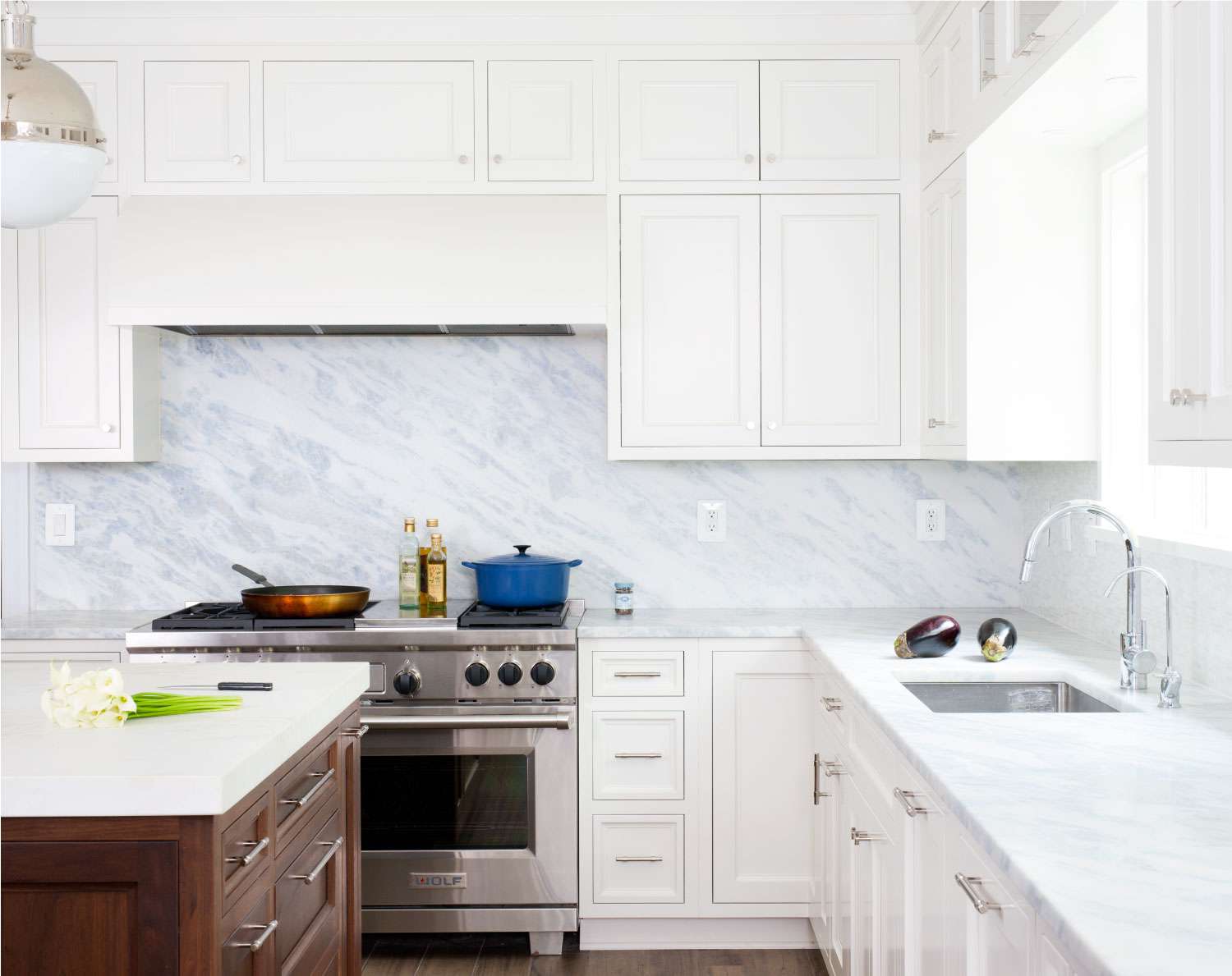 sky blue marble backsplash and counter tops in a white kitchen