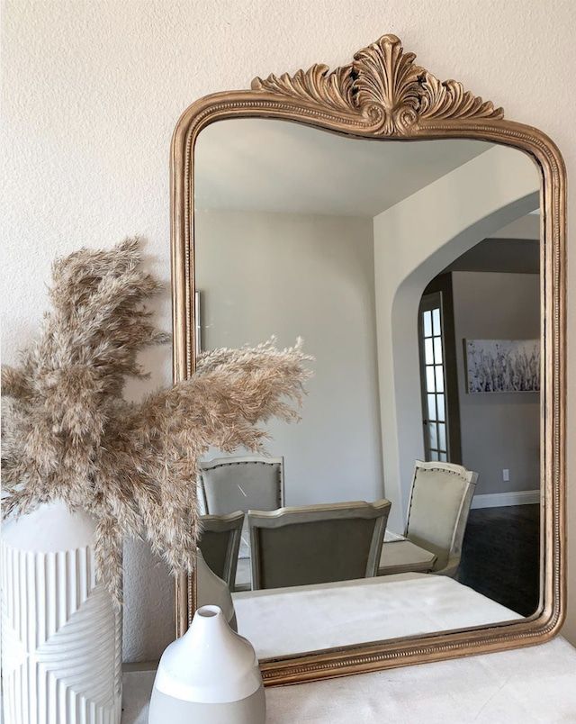 A DIY mirror frame using gold paint and silicone beads