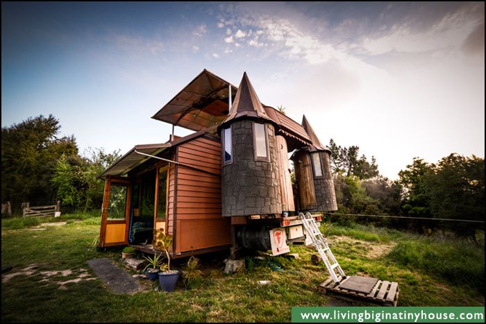Tiny house fashioned like a castle in a backyard 