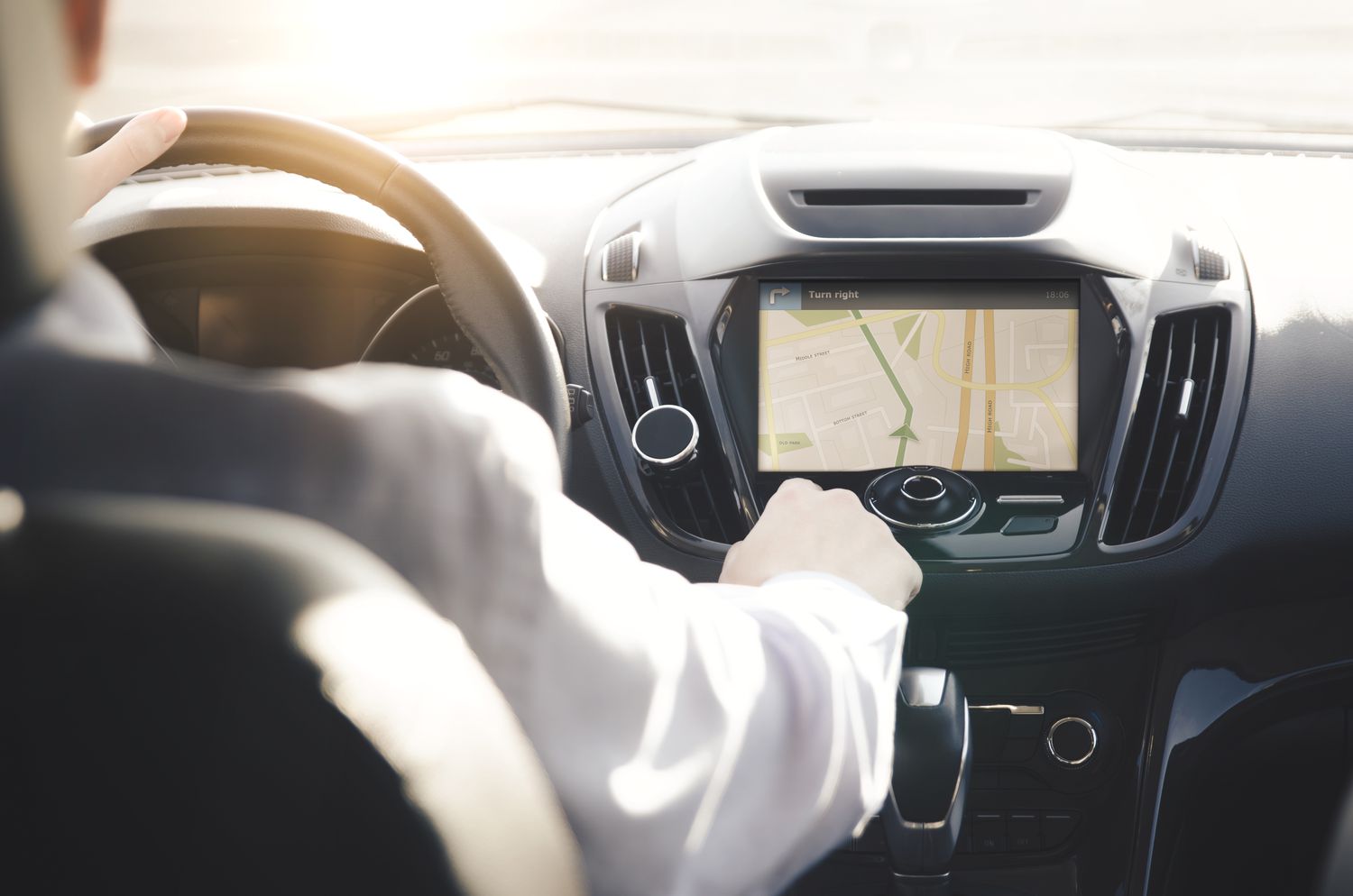 Person driving a car with GPS navigation