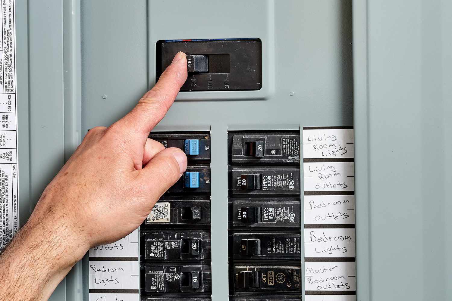 person switching off the main power service before beginning work