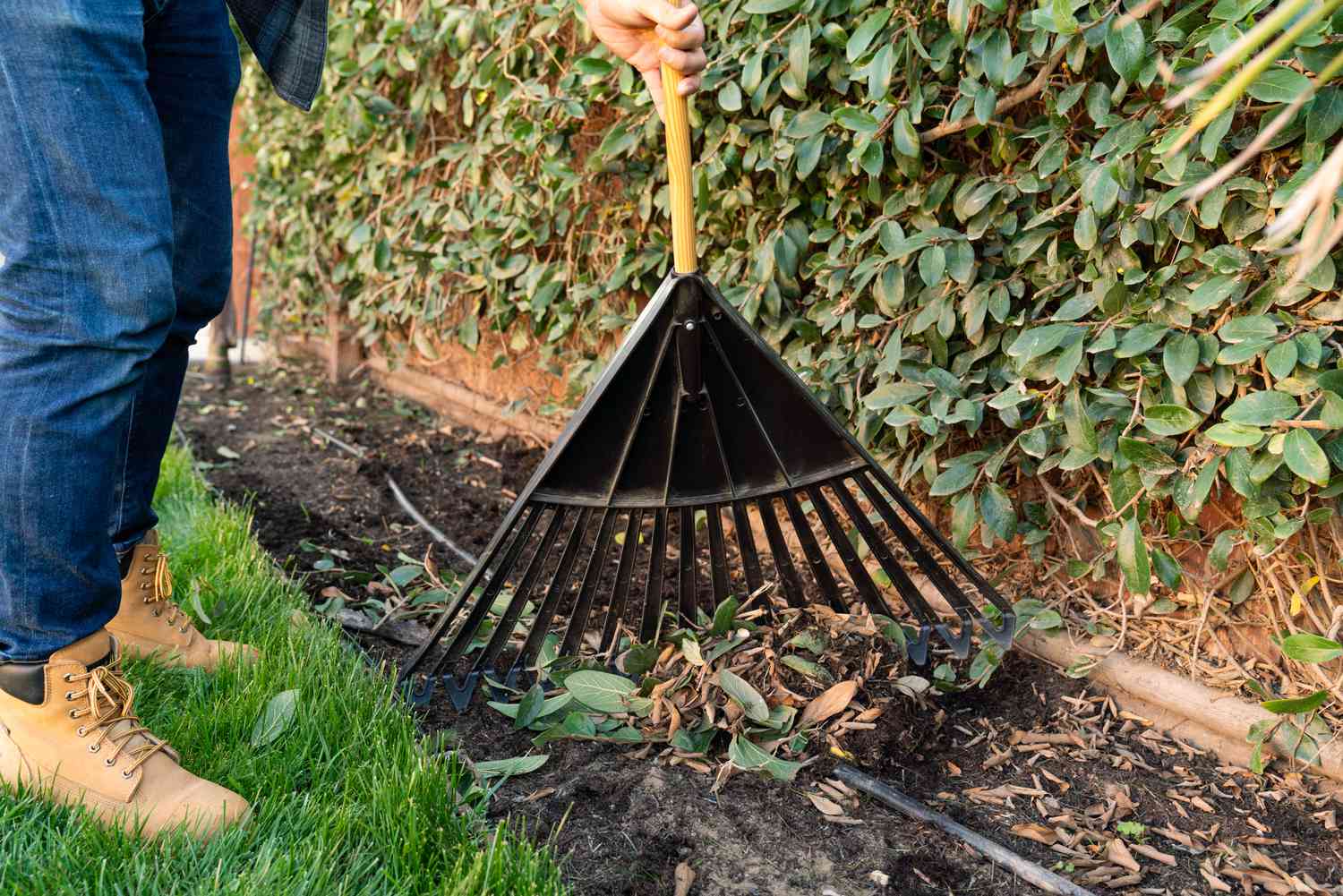 Person using a garden rake