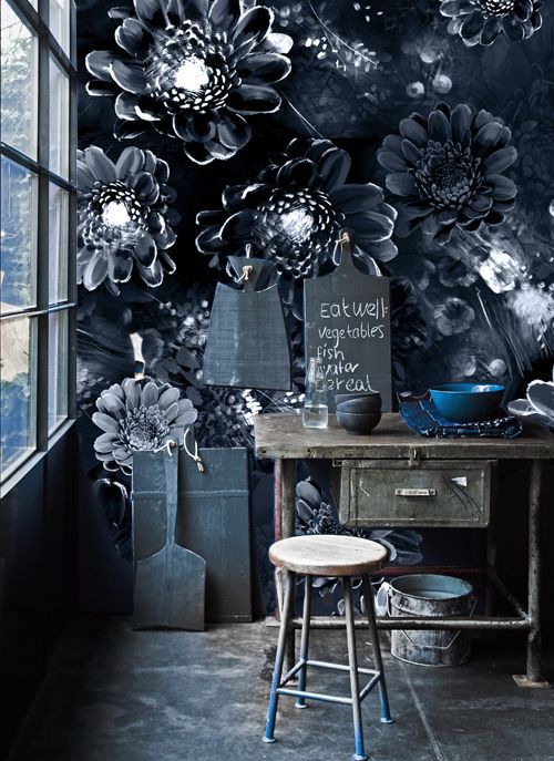 workspace with dark wallpaper with large floral print with bright natural light