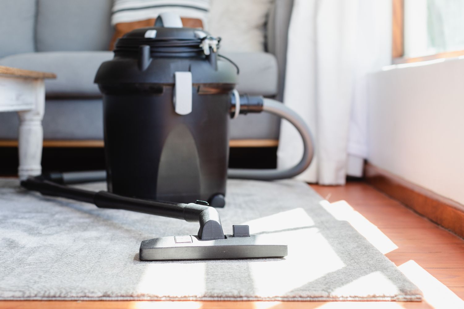 Upright vacuum cleaner resting on carpet