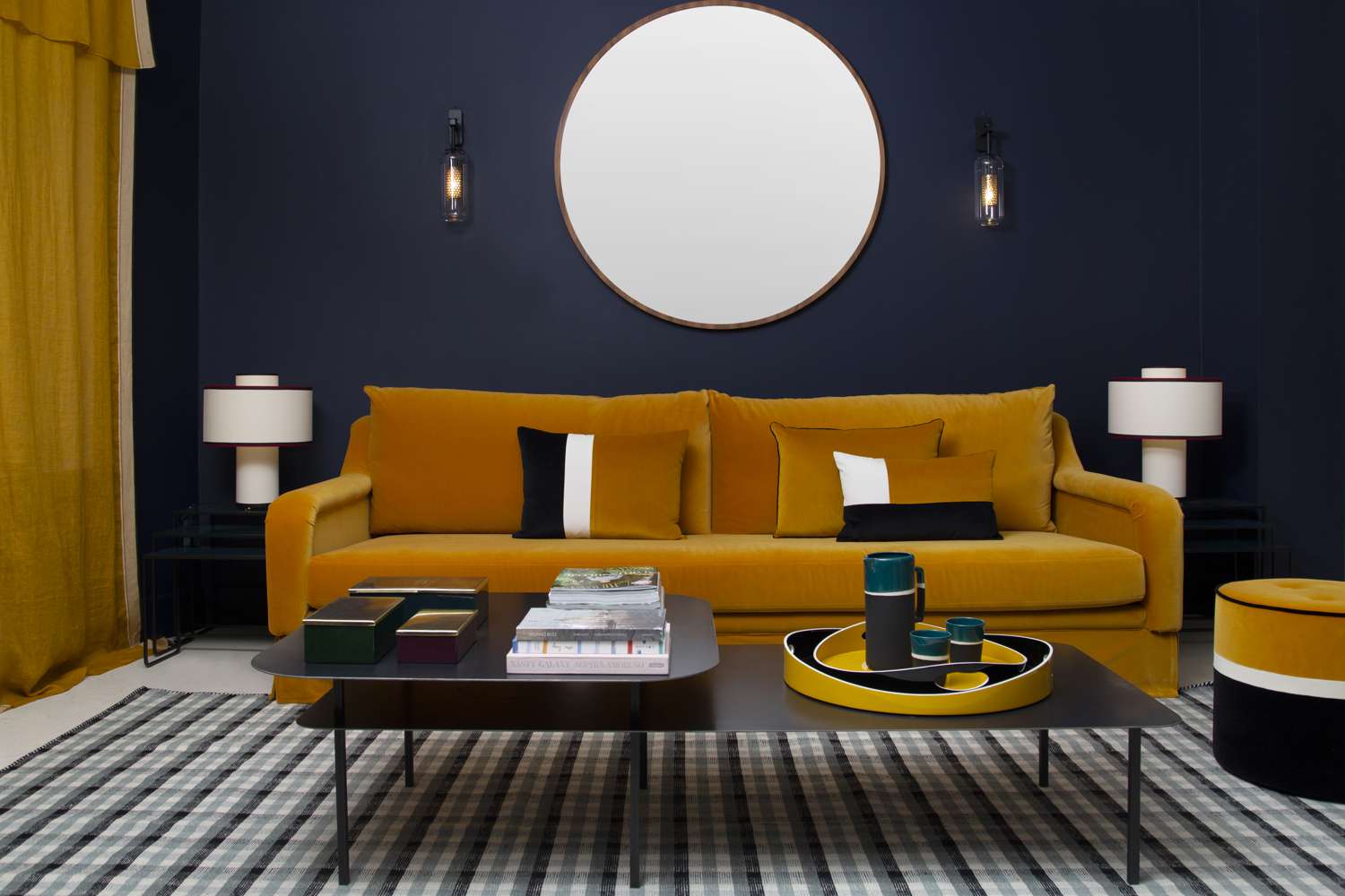 Ochre couch navy walls by Sarah Lavoine.