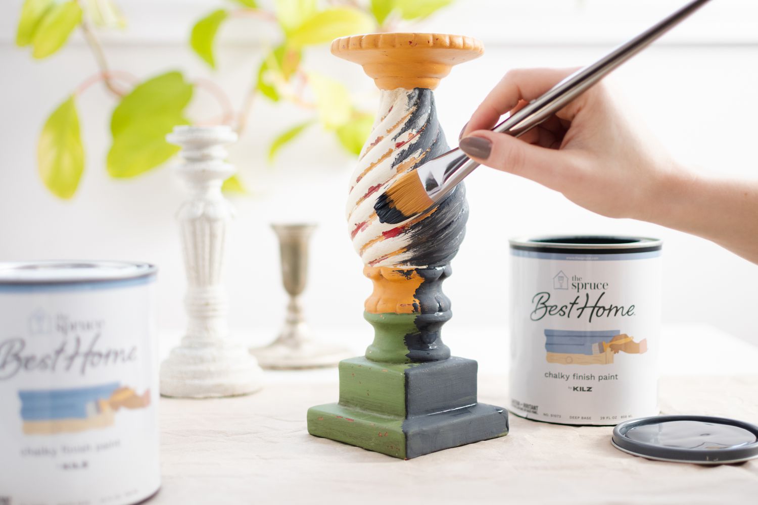 Chalk paint applied to candlestick with paint brush