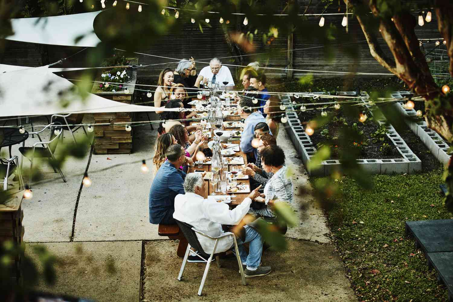 Overhead view of family seated together on outdoor patio for celebration dinner