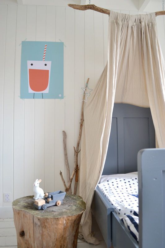 Kids room with rustic DIY canopy created from a tree branch.