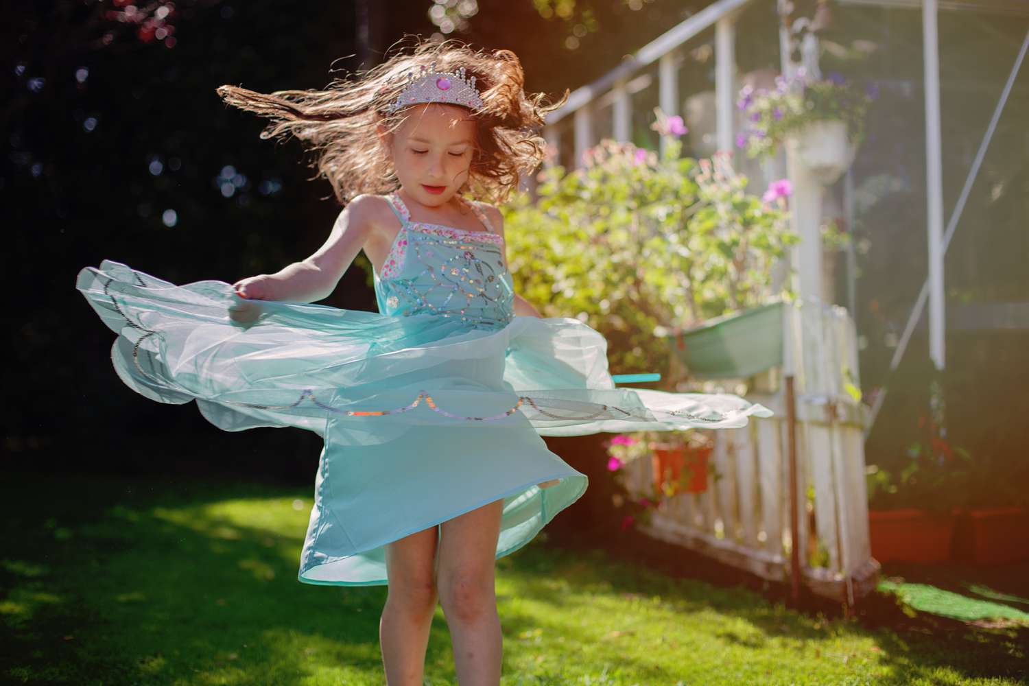 girl ( 5) dancing in field in princess dress