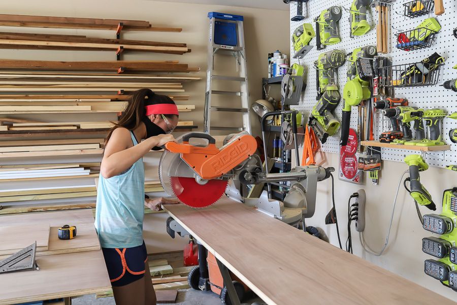 Jen Woodhouse mit Gehrungssäge beim Holzschneiden in der Werkstatt
