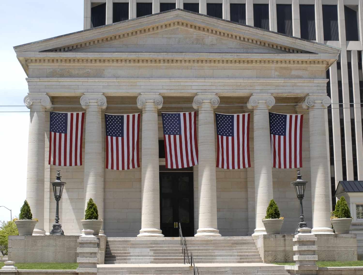 Palacio de justicia de estilo renacimiento griego con banderas americanas.
