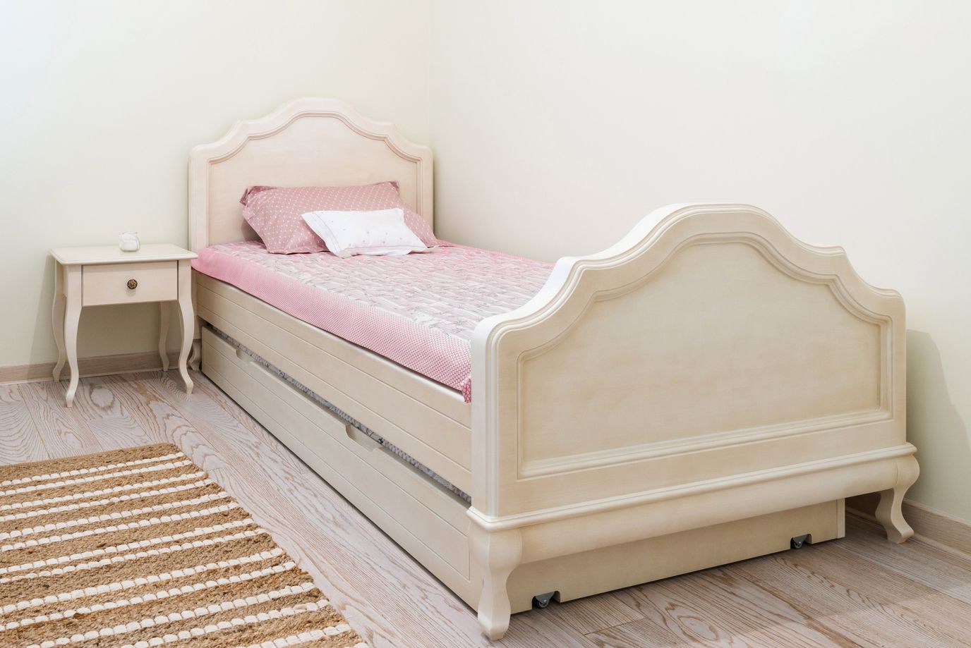 Angled view of a trundle bed with a pull out drawer