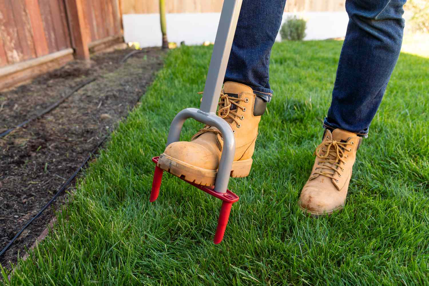 Person using a lawn aerator