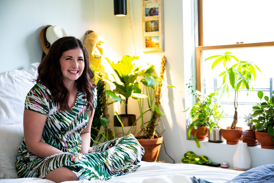 Maria Failla, fundadora da Bloom and Grow Radio, rodeada de plantas em sua casa
