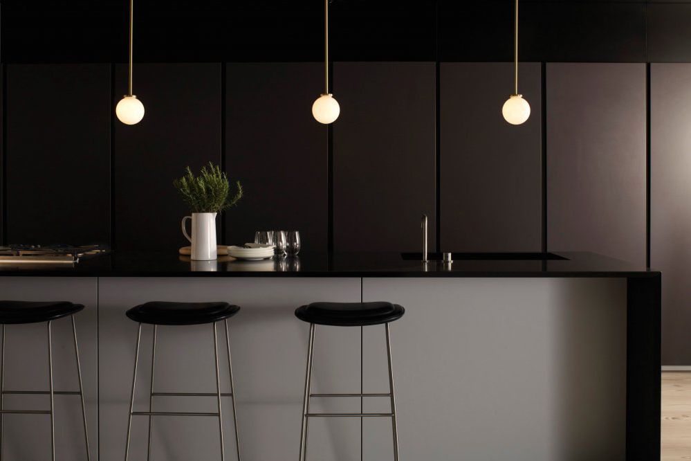 pitch black kitchen with small pendant lights