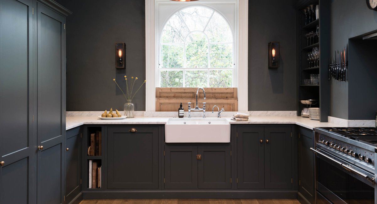  kitchen with black cabinets and walls with white counter tops