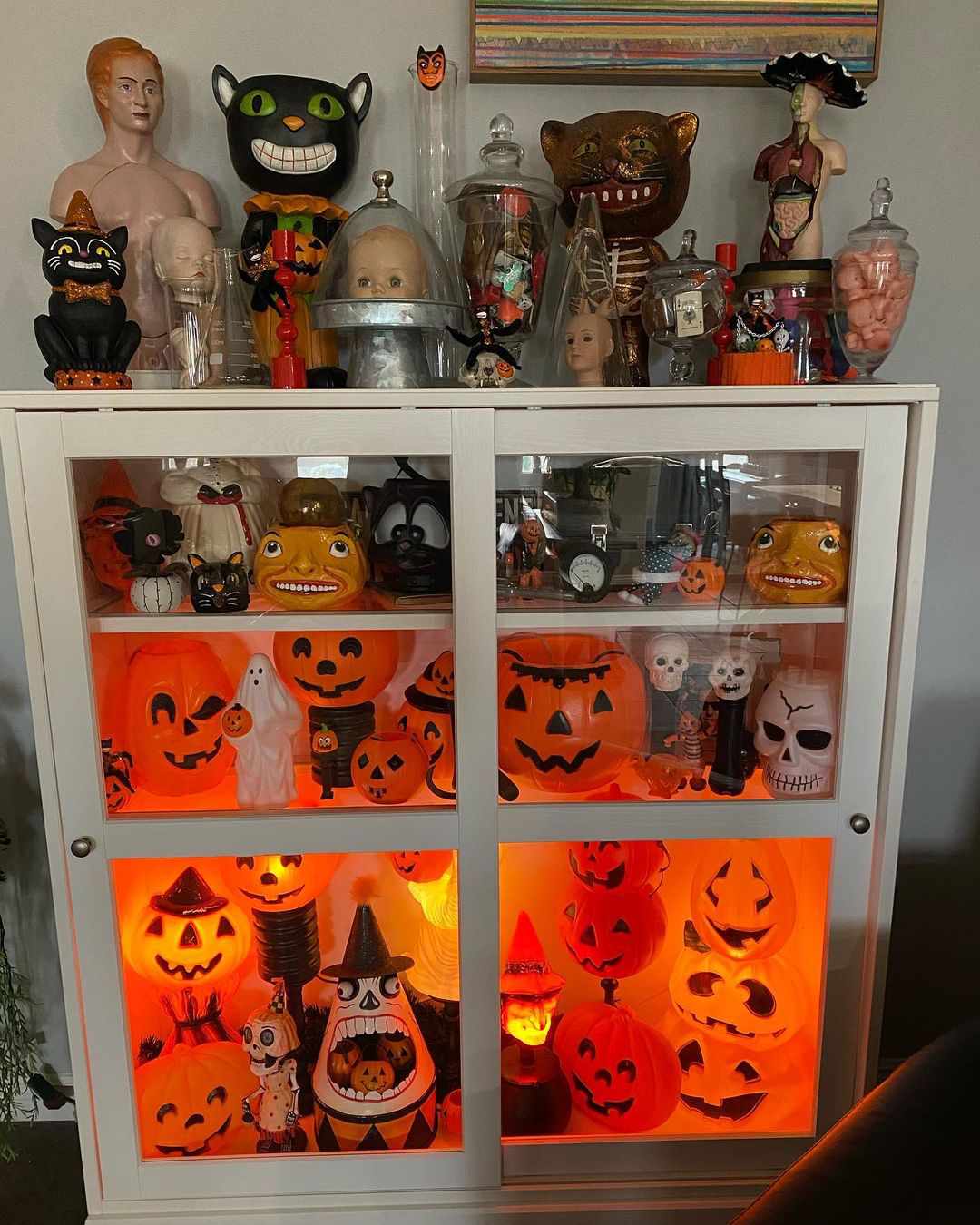Cabinet display of pumpkins and more.