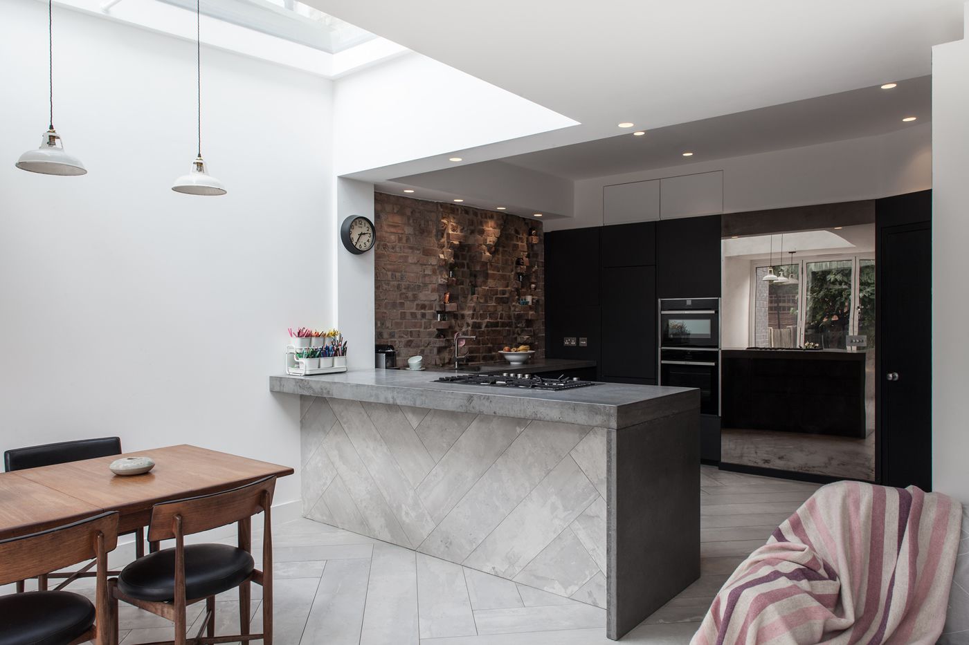 black kitchen in white open concept home