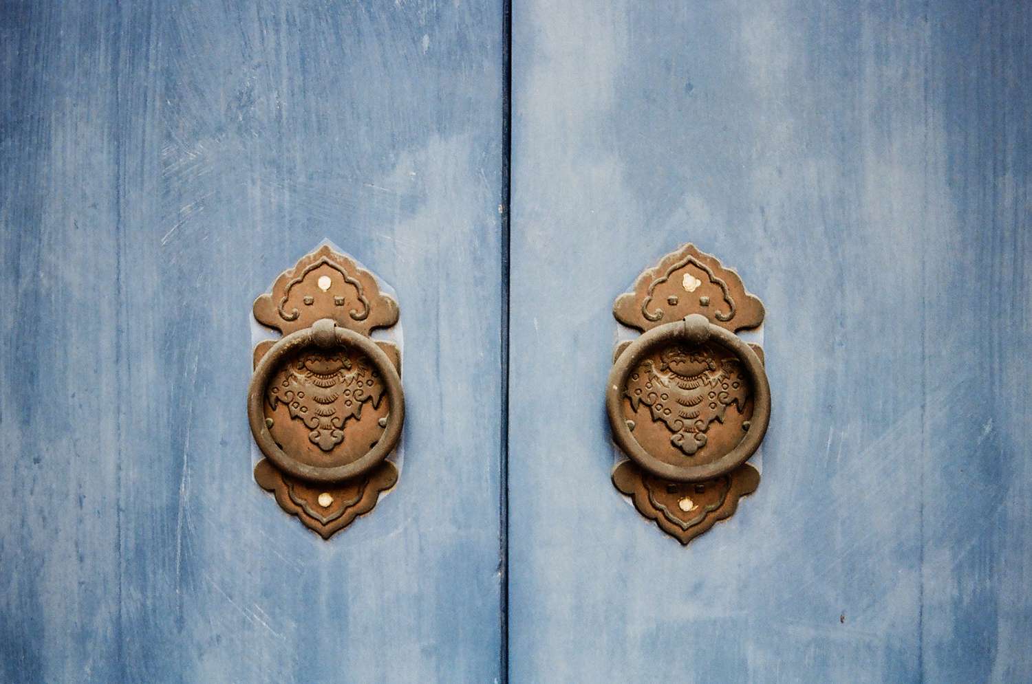 Door knocker on blue temple doors