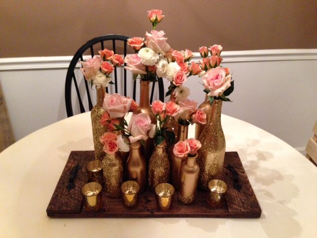 gold bottle centerpiece with pink flowers