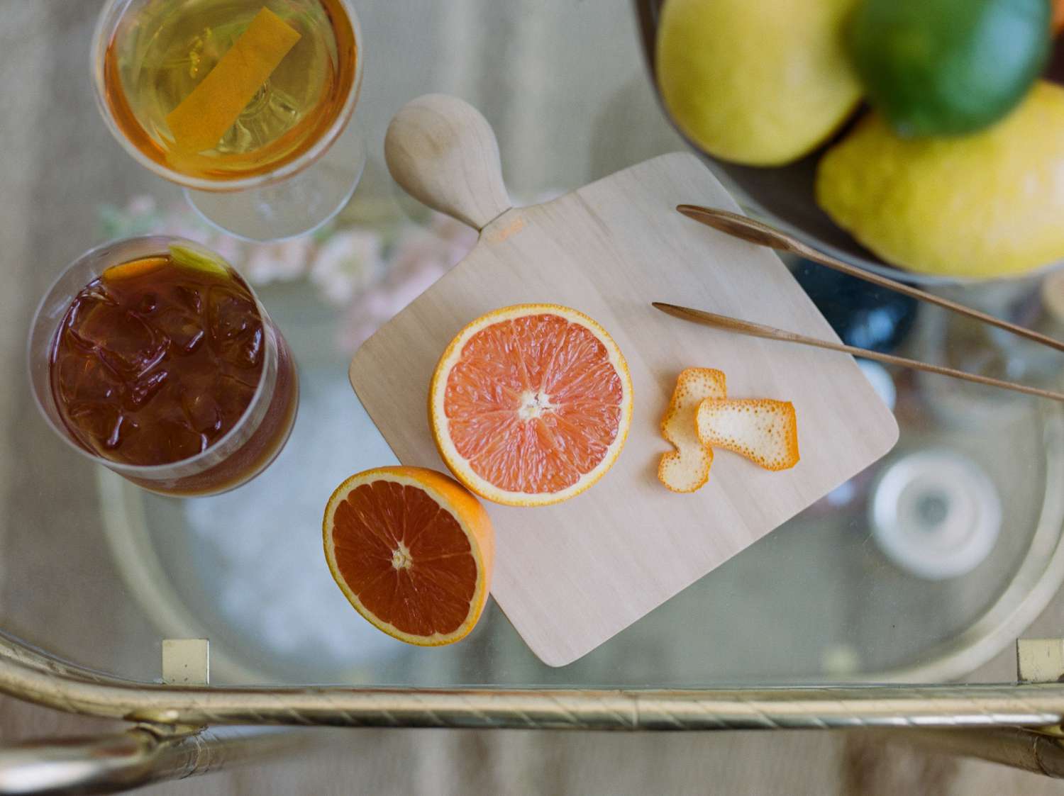 Close up of Orange Cut open with peel on cutting board bar cart