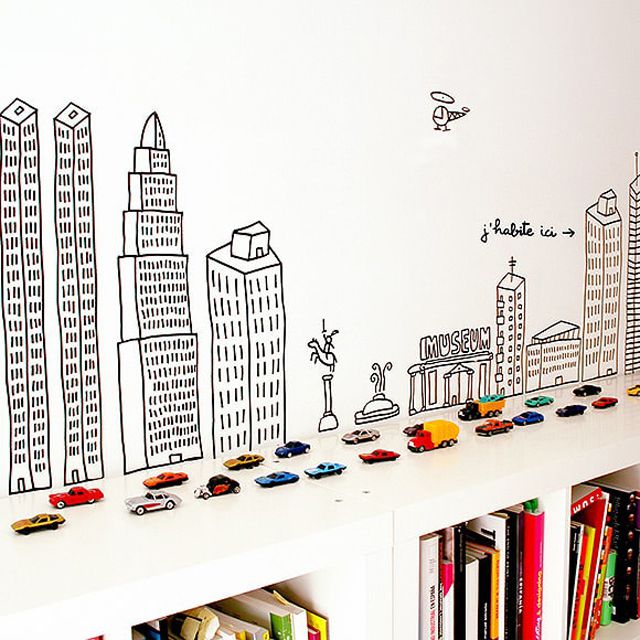 Sharpie cityscape mural on white wall above bookcase 