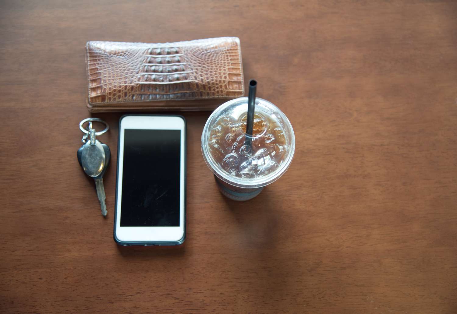 High Angle View of Smart Phone and Drink With Purse
