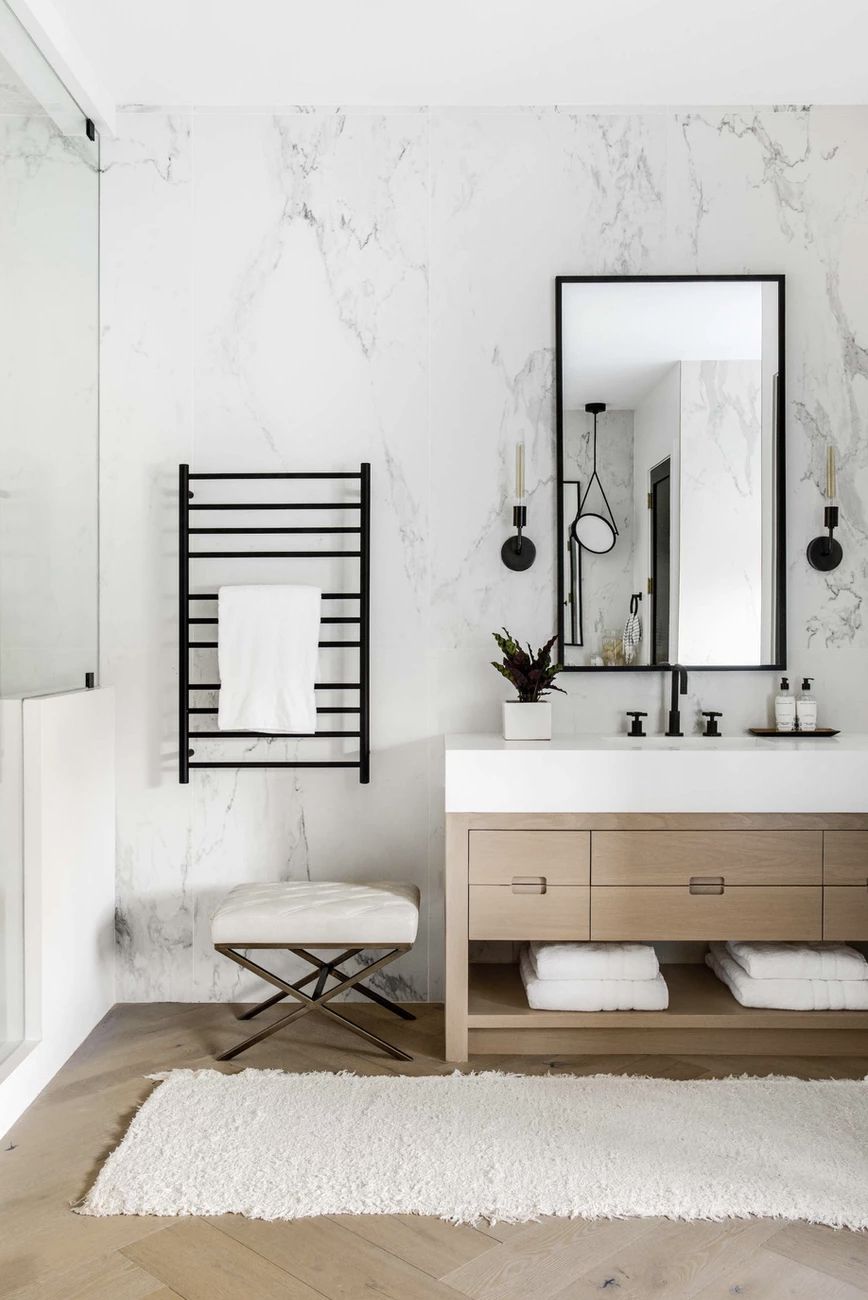 modern marble bathroom with black and wood accents