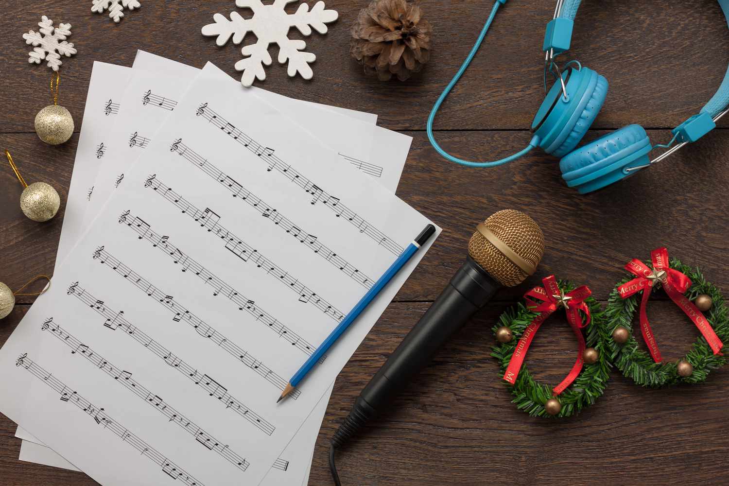 Table top view of music sheet note and accessories Merry Christmas & Happy new year concept.Instrument musical with decoration festive on the modern rustic dark brown wooden at home office desk.