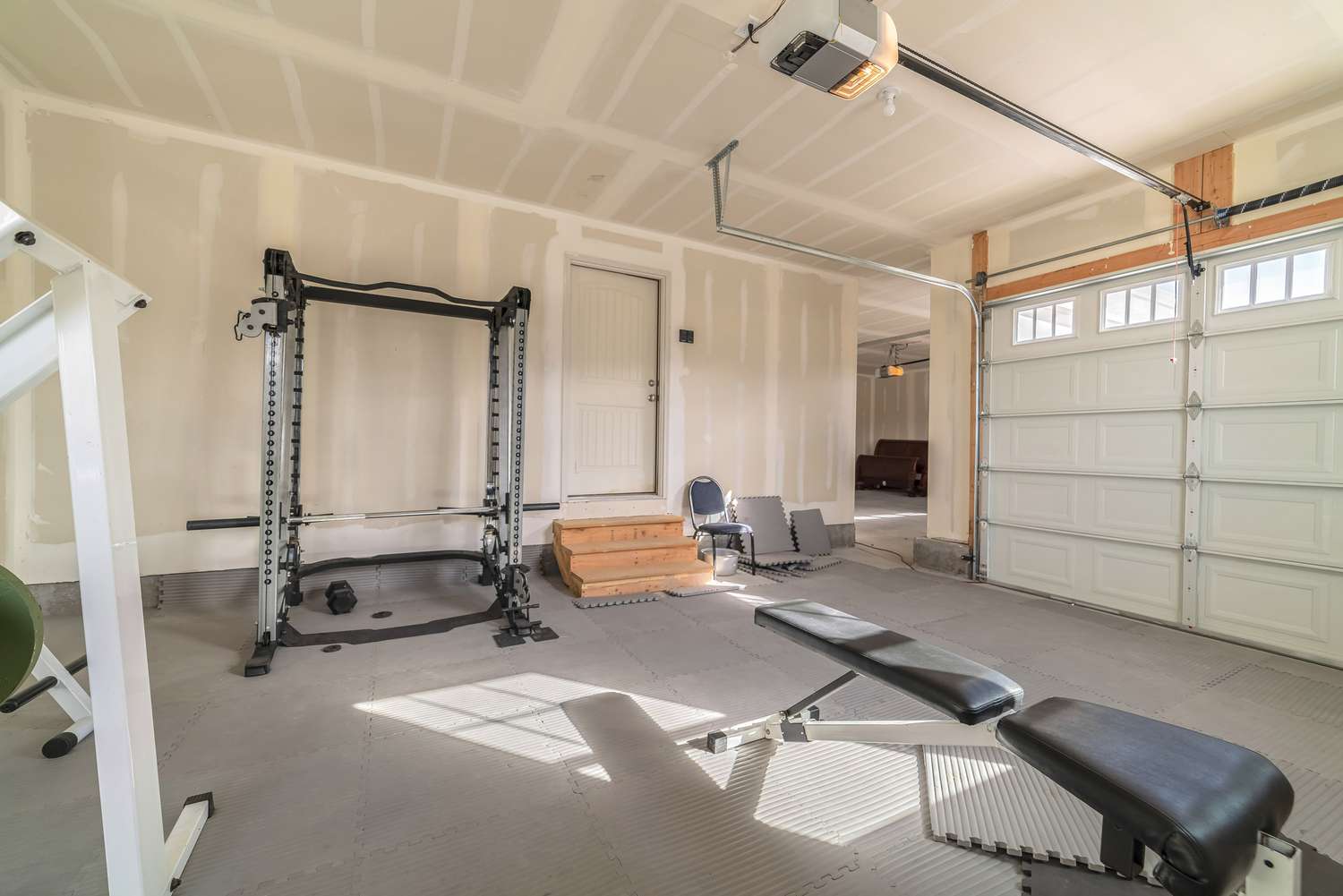 Assorted gym and fitness equipment in a garage