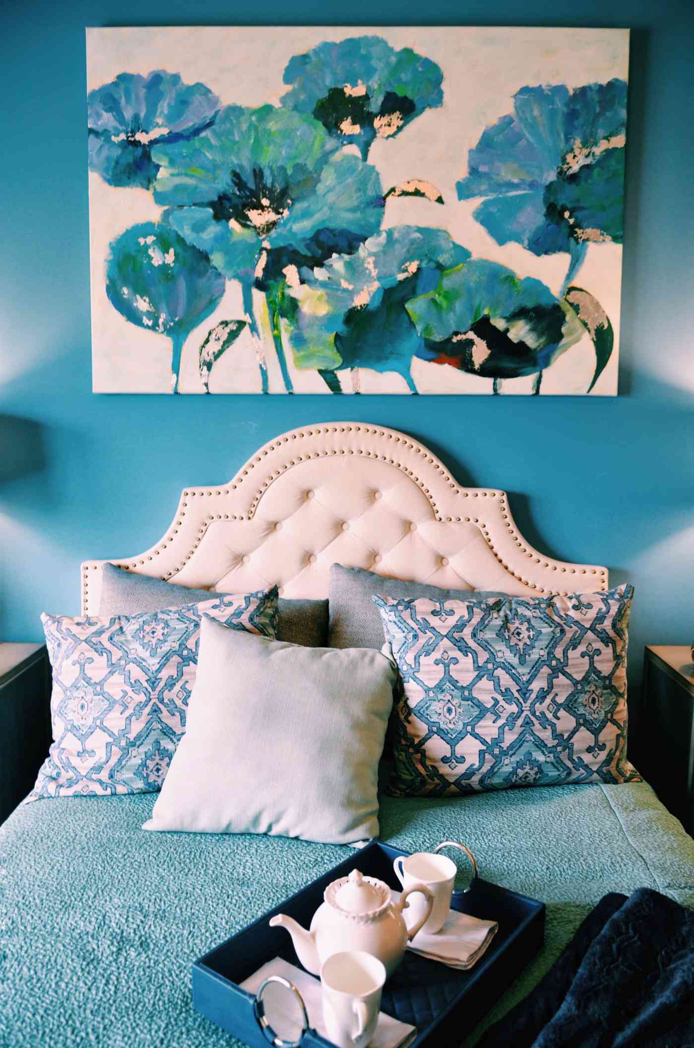 Bold artwork in the bedroom creates a stunning focal point