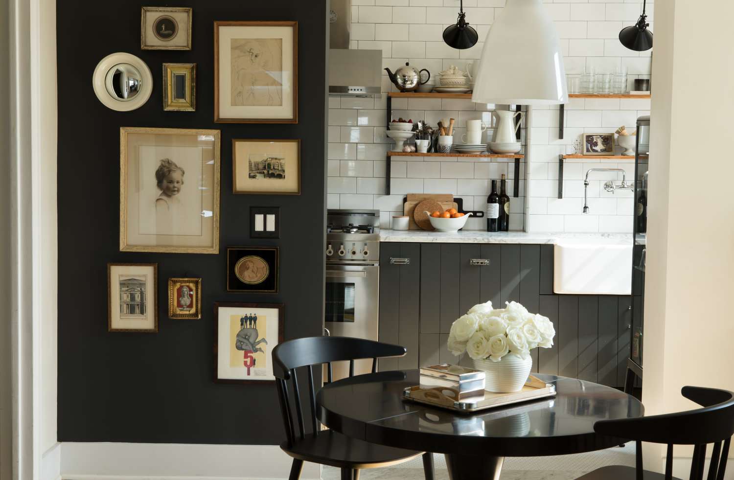 Black kitchen cabinets in black and white country-esque kitchen with wood accents