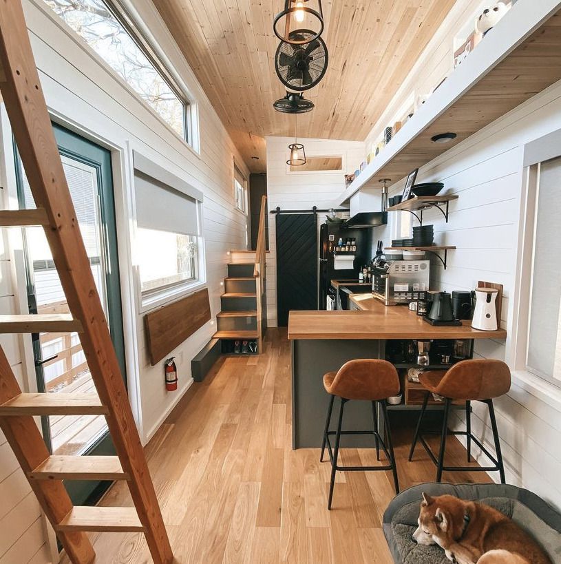 tiny home with upper ledge and dark trim/cabinets