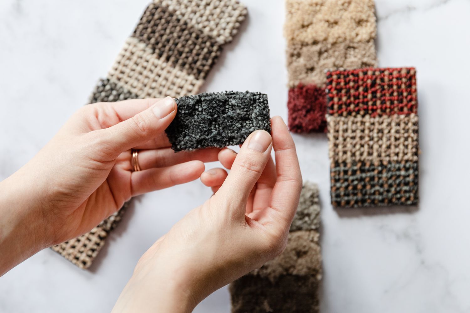 Carpet swatches held up to determine weight