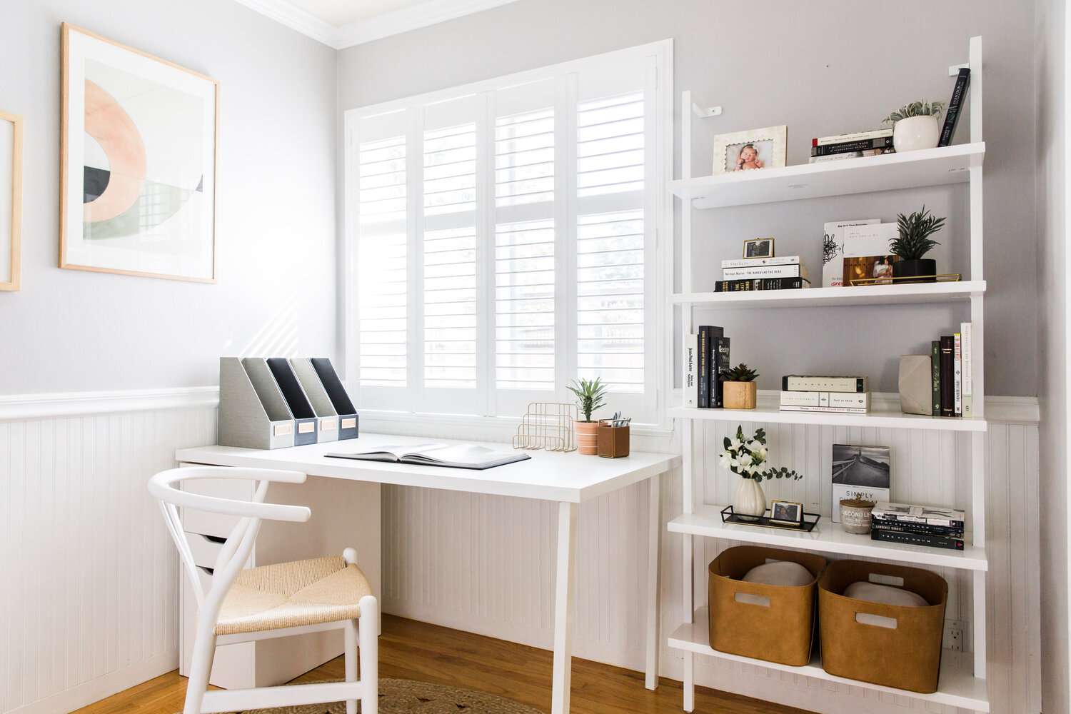 modern room with white table desk set up in the corner