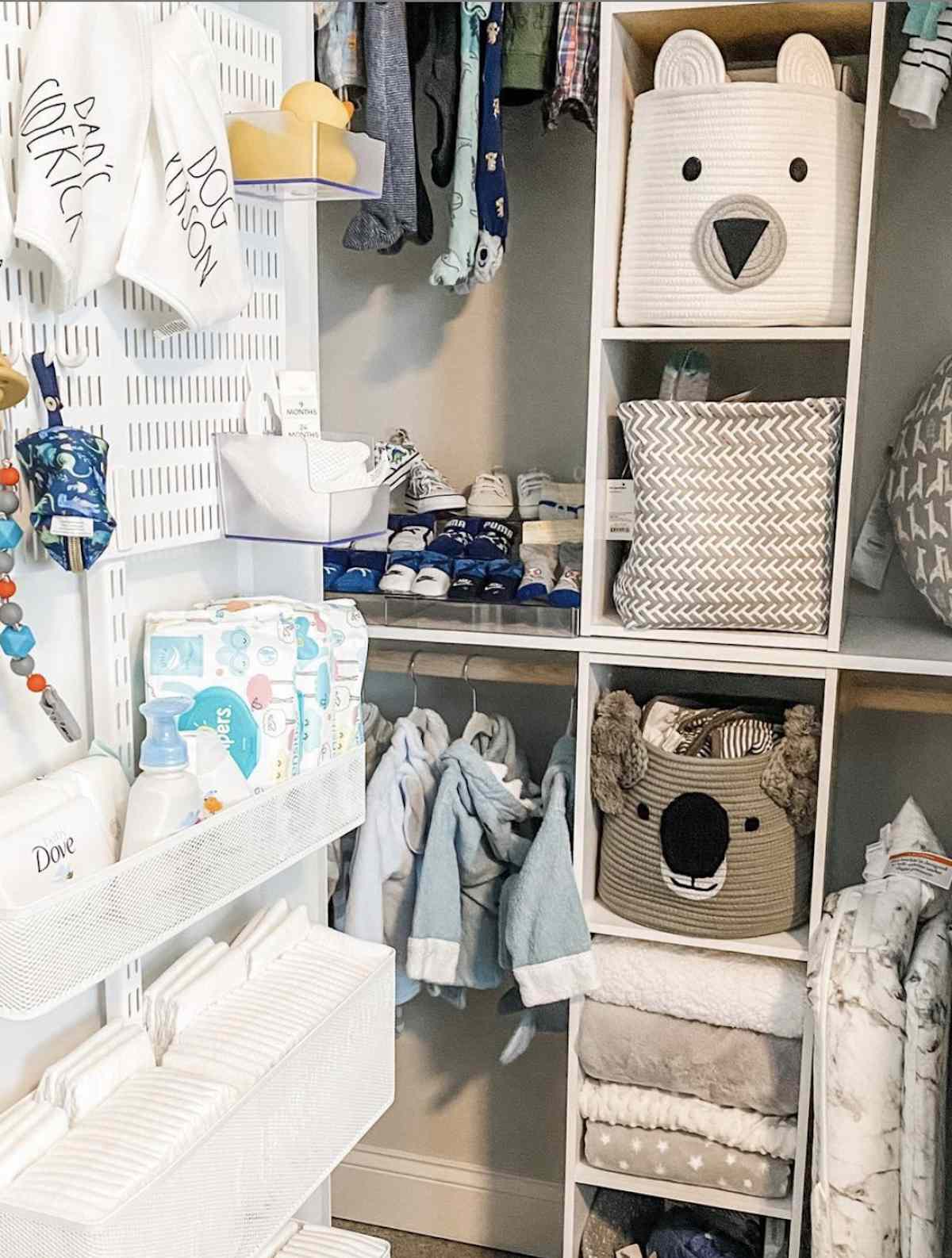 nursery closet with storage bins inside, peg boards and shelves hung on door